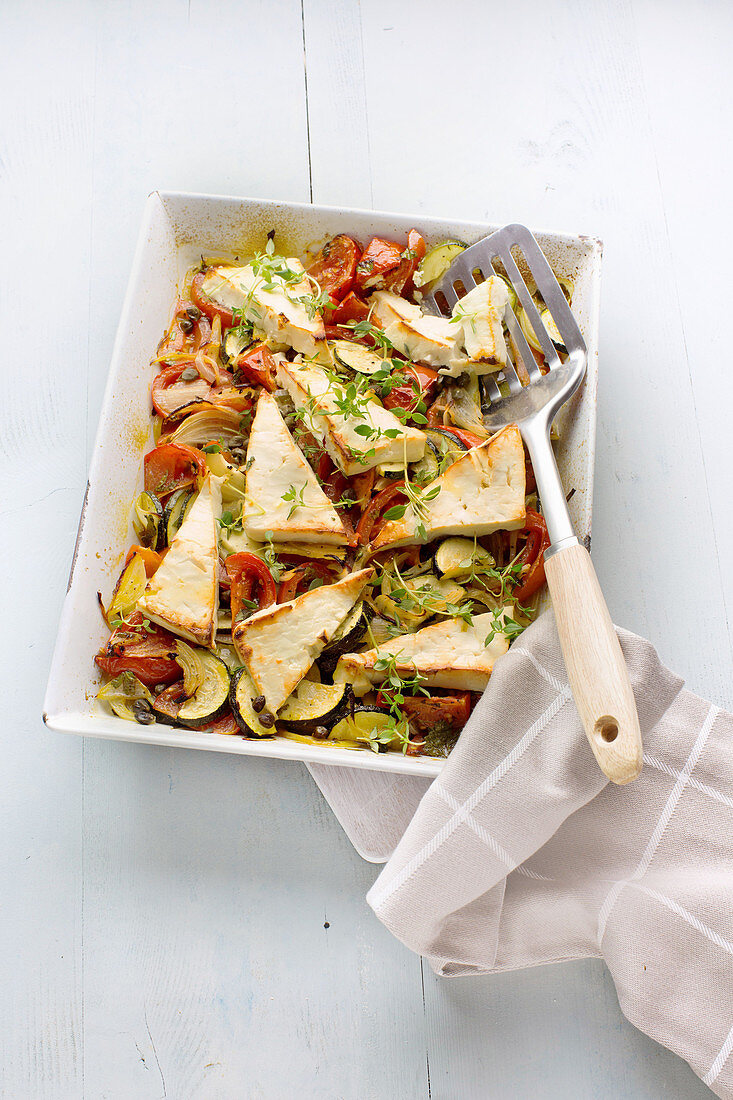 Baked feta with zucchini, tomatoes and capers