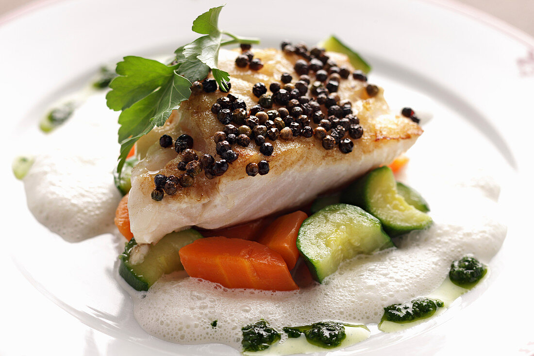 Cod fish with vegetables and basil olive oil