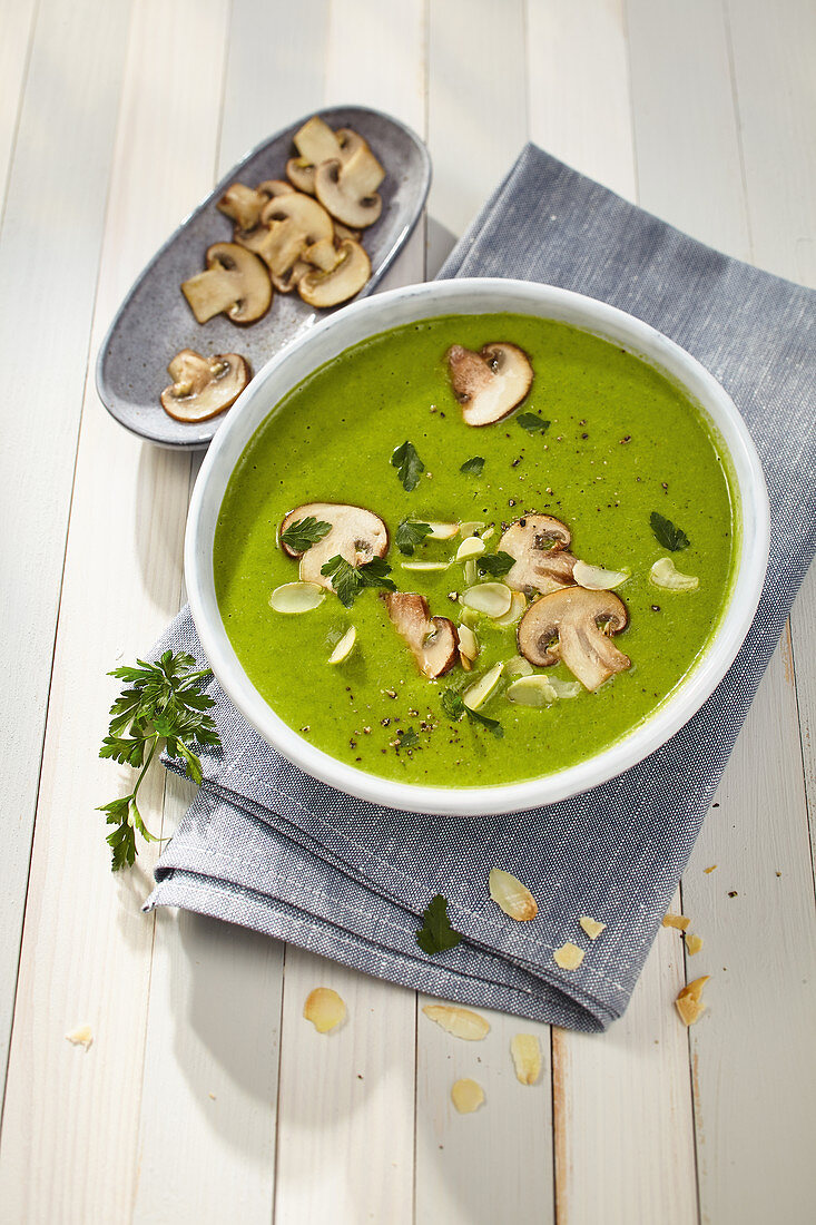 Cream of potato and pea soup with lettuce and roasted mushrooms