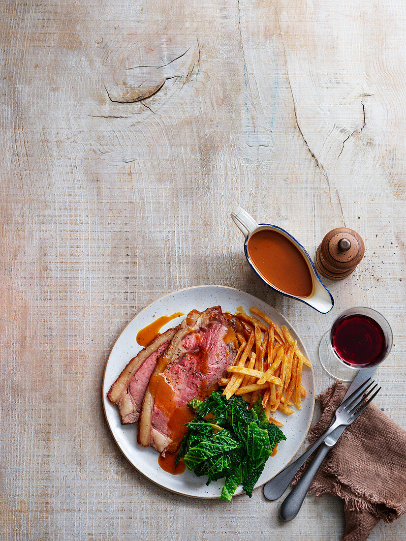 Roast yearling beef with french fries and kale