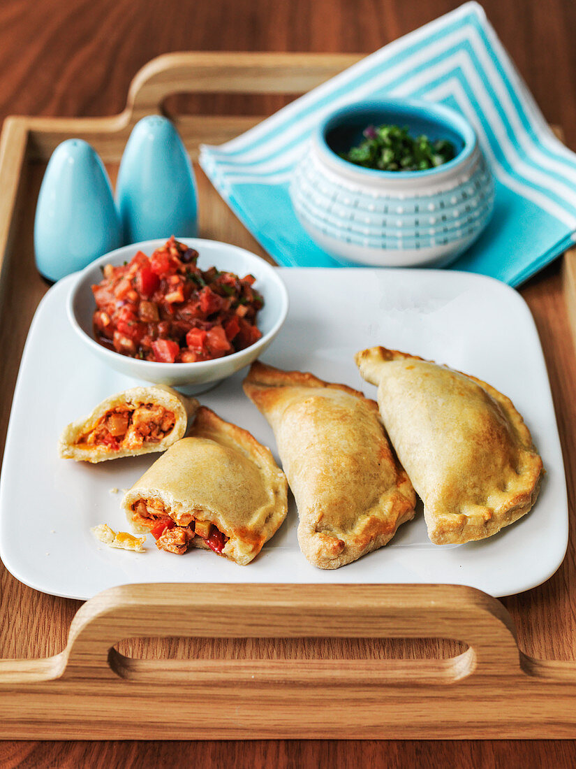 Argentine empanadas served on a tray with chilli relish