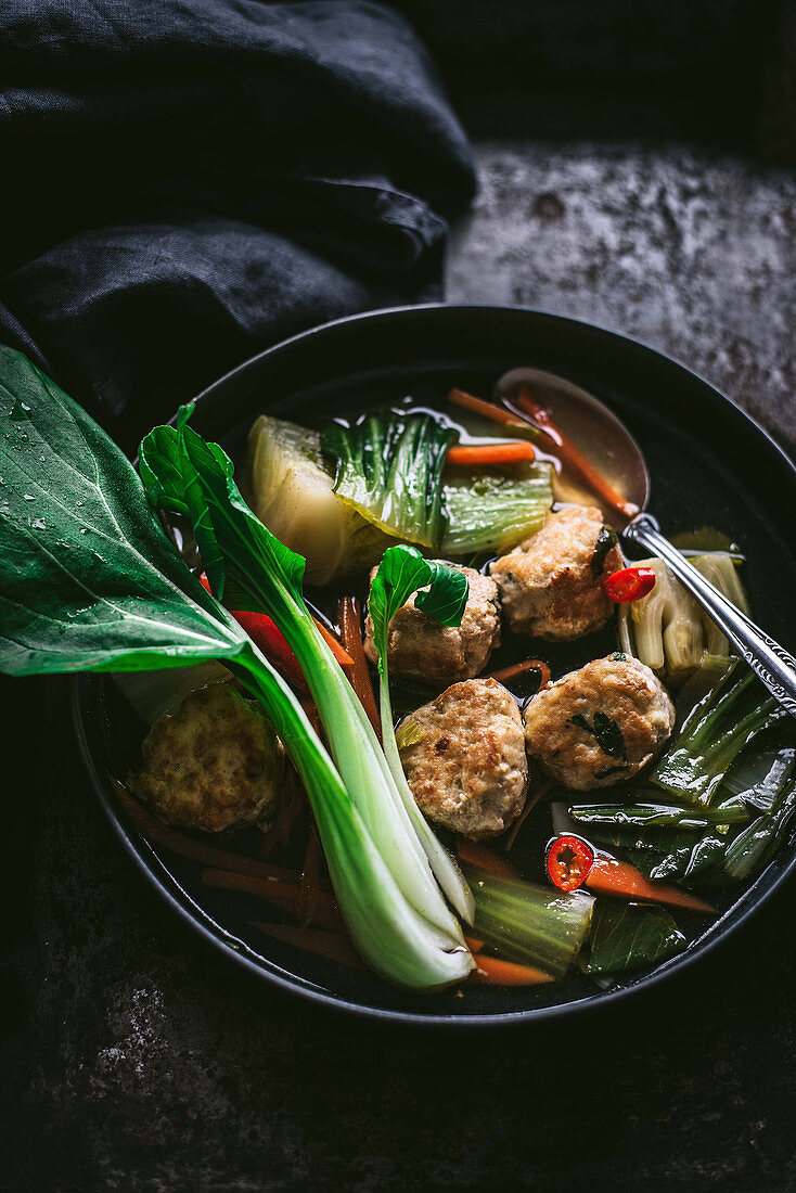 Asian meatballs in spicy bok choy and ginger soup