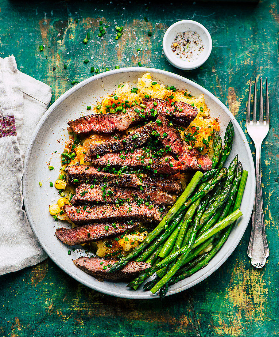 Beef steak with potato and corn puree and green asparagus