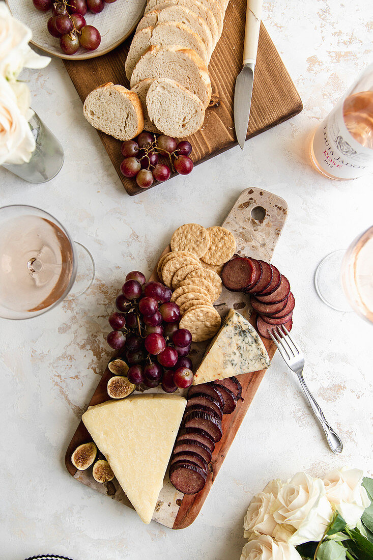 Cheeseboard with sausage, grapes and crackers