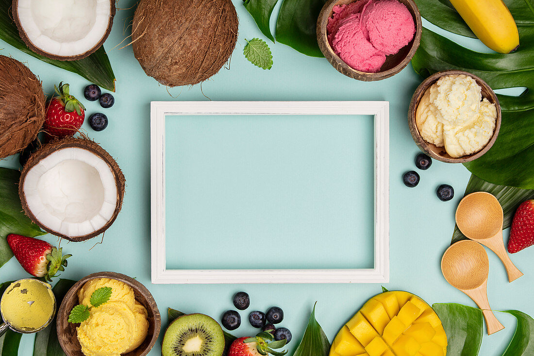 Tropical fruits and plants with ice cream in coconut shells