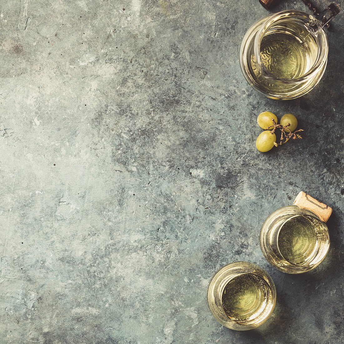 Glasses of white wine on rustic background