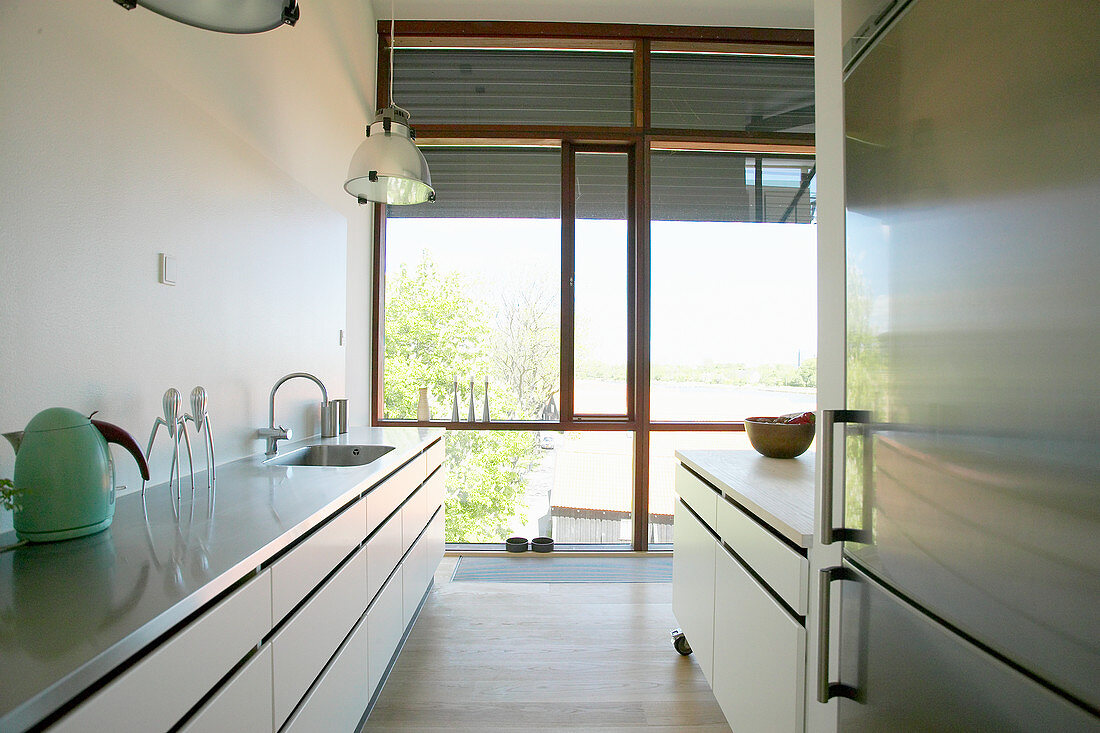 Kitchen with glass wall in loft apartment