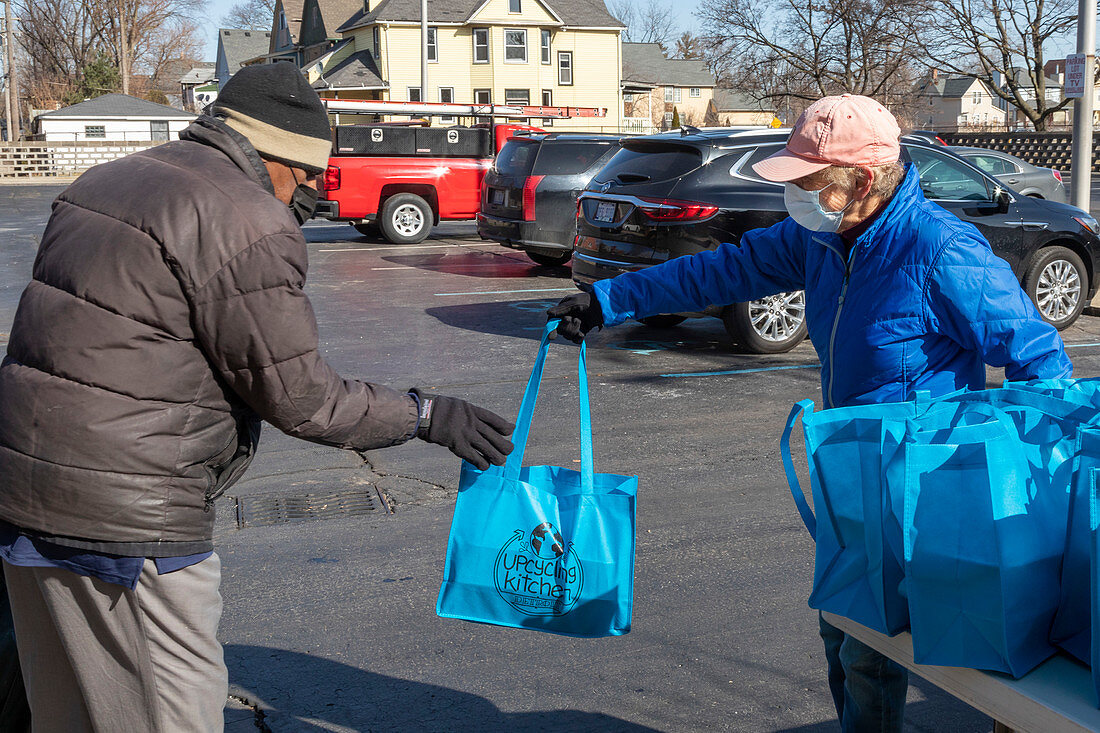 Volunteer distributing meals, Michigan, USA