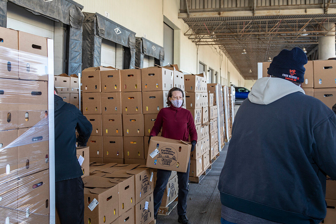 Volunteers distributing boxes of food