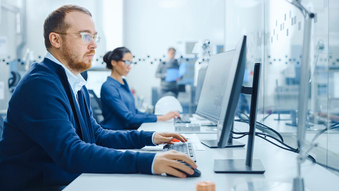 Industrial engineers working in a factory office