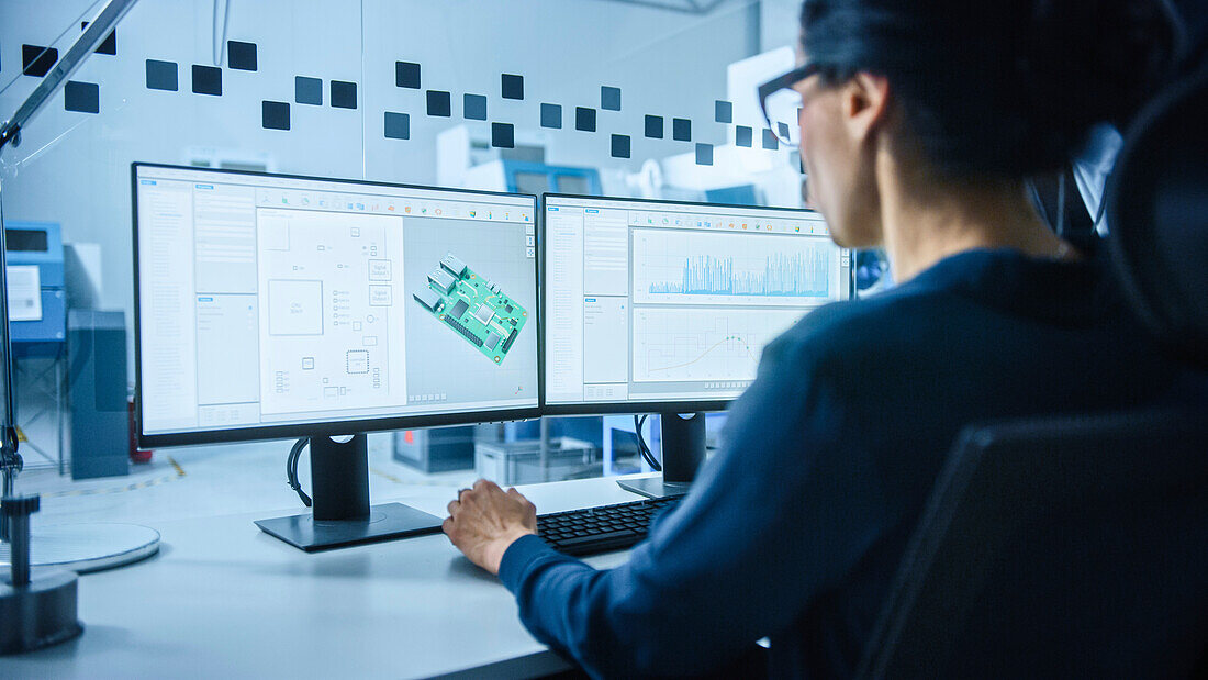 Electrical engineer using CAD software on a computer