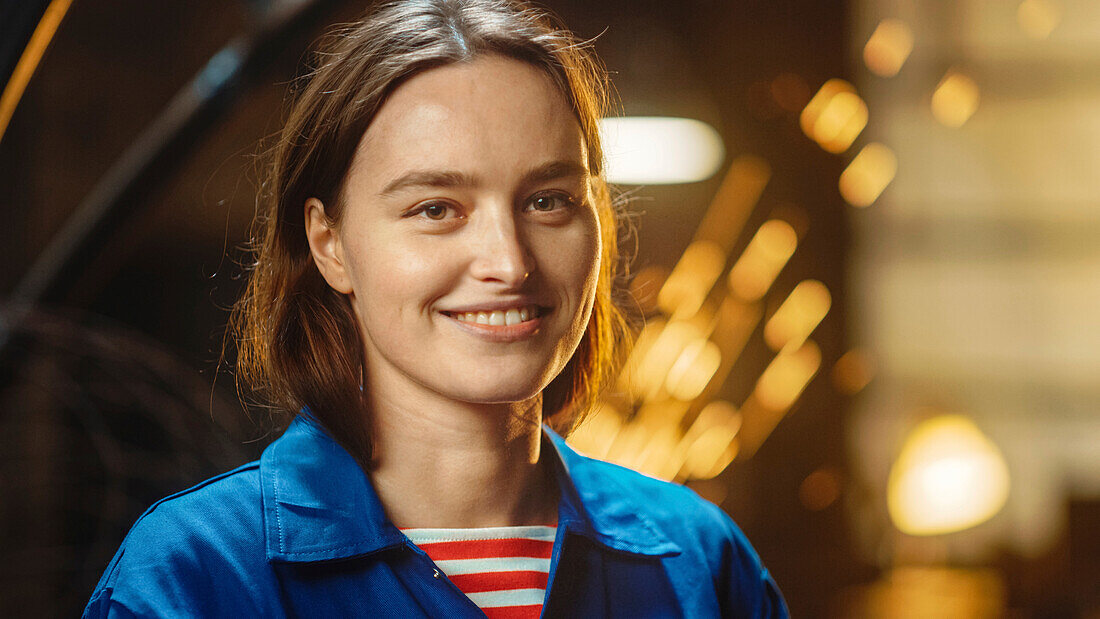 Smiling woman in workshop clothing