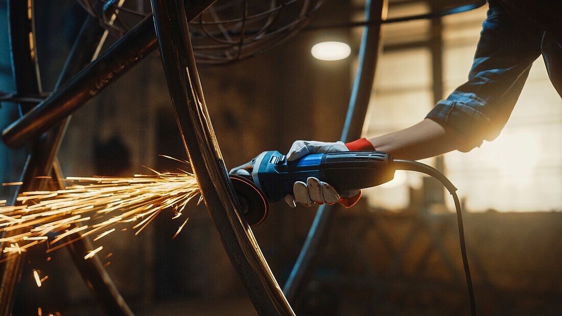 Sculptor grinding a metal sculpture