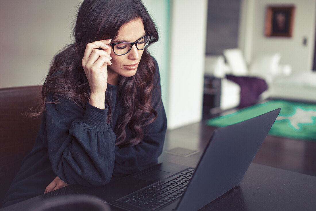 Tired young woman in home office