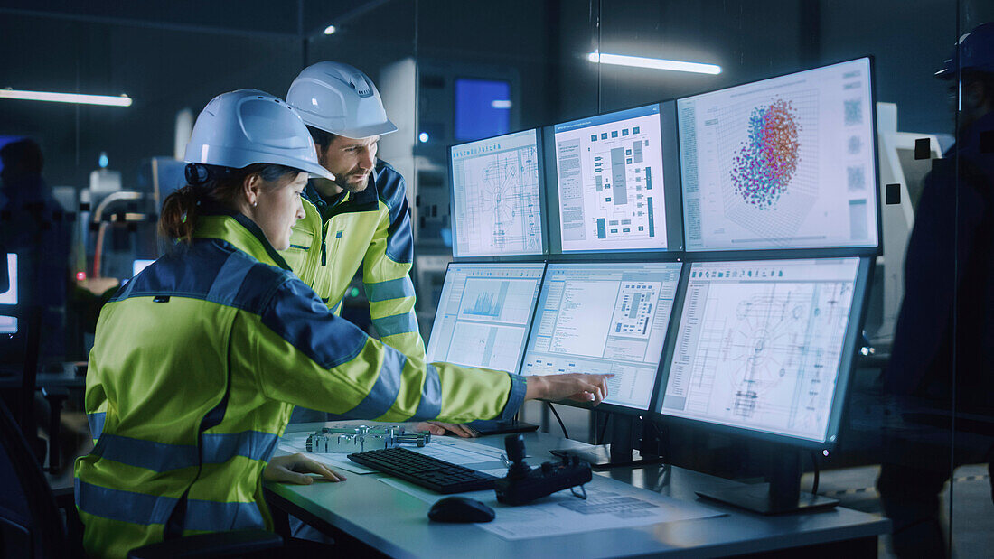 Engineers in factory control room