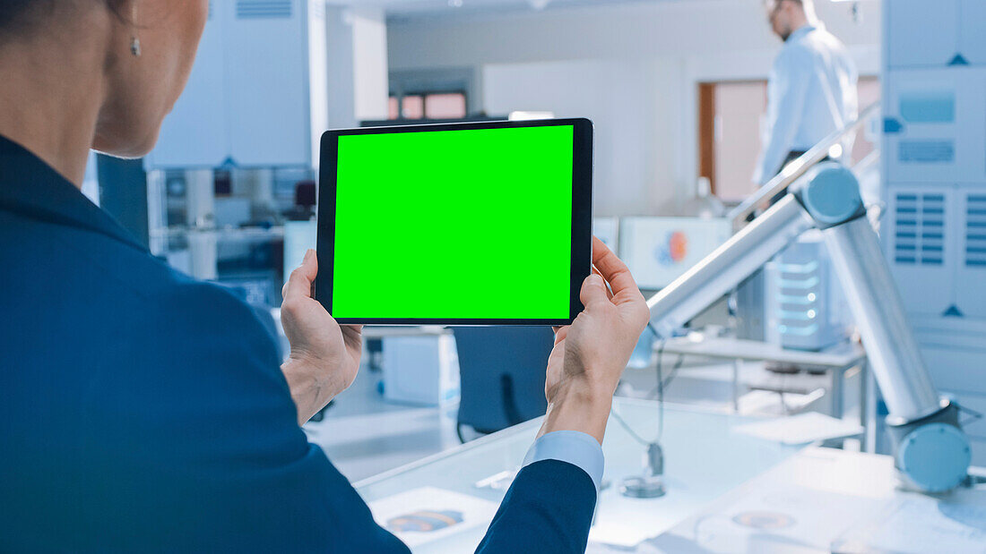 Engineer holding a green screen tablet