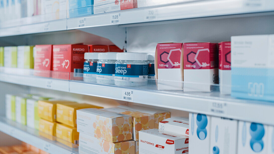 Shelves lined with medications in a pharmacy