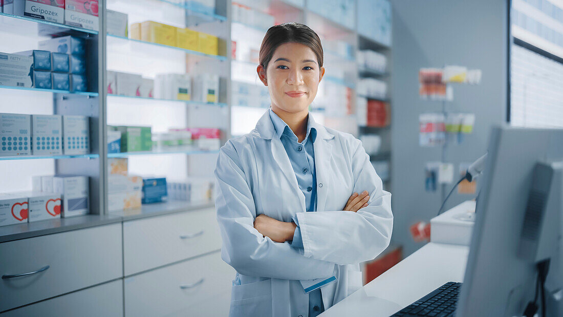 Smiling pharmacist wearing a white lab coat