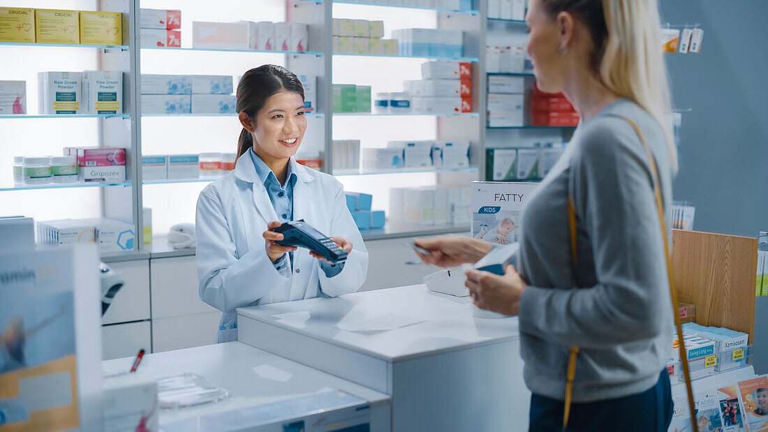 Pharmacist recommending medication at the counter