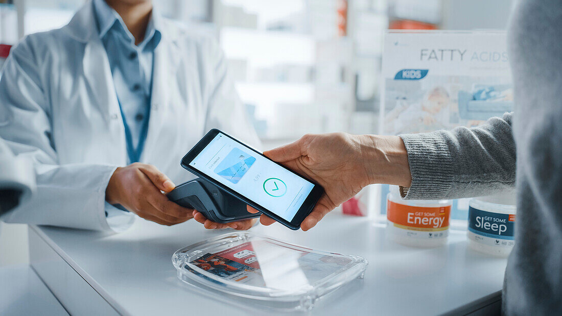 Customer using contactless payment in a pharmacy