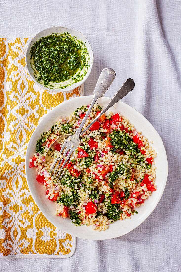 Giant couscous and tomato salad with zhoug-style dressing