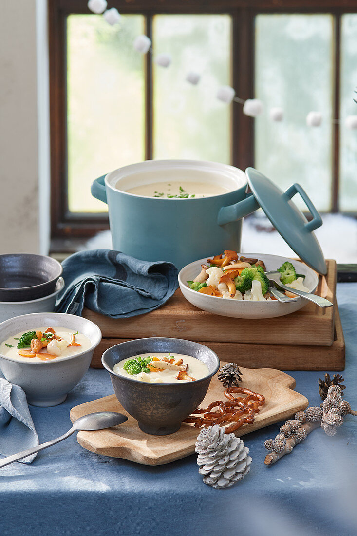 Cheese fondue soup with fried vegetables and chanterelles