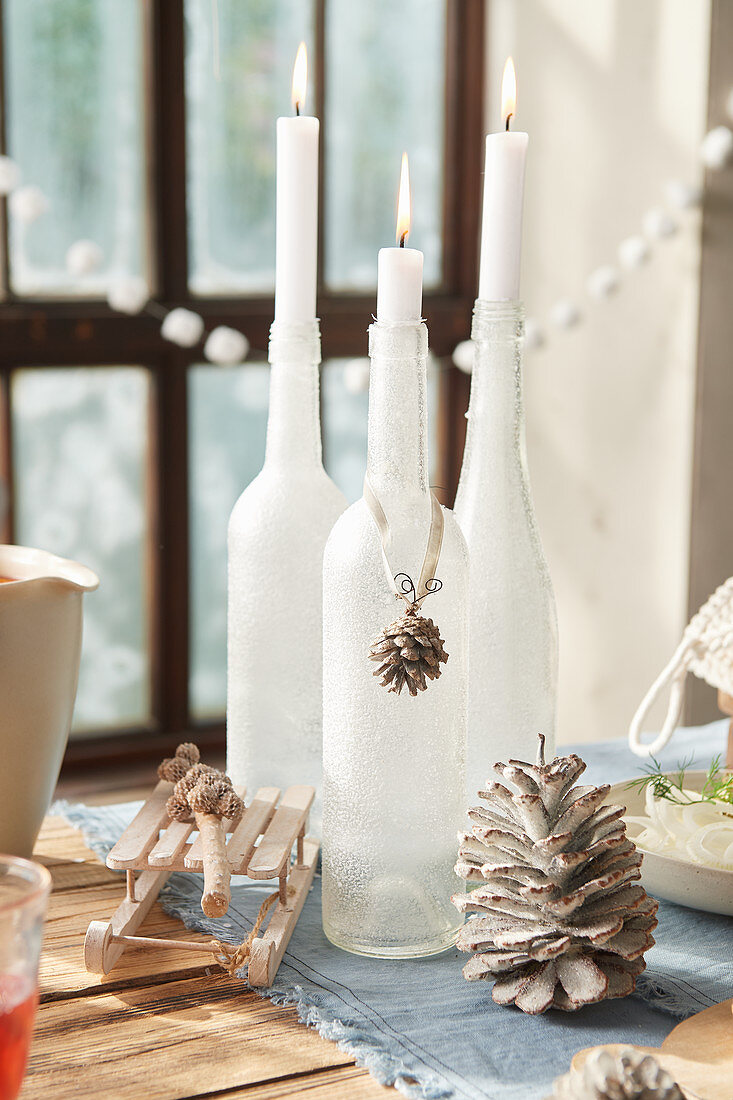 Frosted bottles used as candlesticks