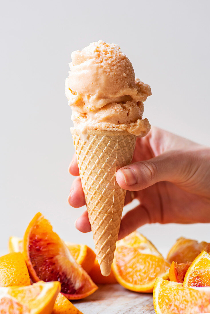 Homemade orange sherbet in ice cream cone