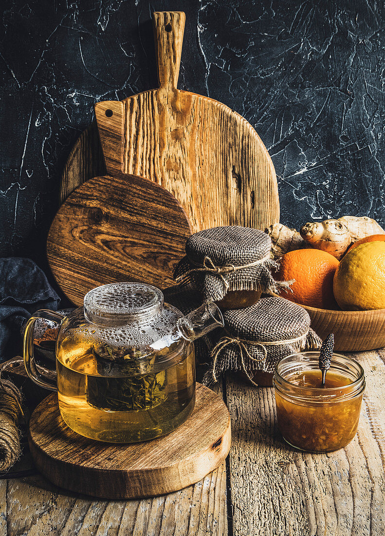 Hot tea and marmalade on a wooden background