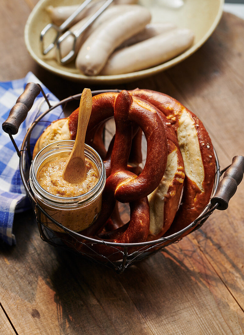 Sweet mustard and pretzels with white sausages
