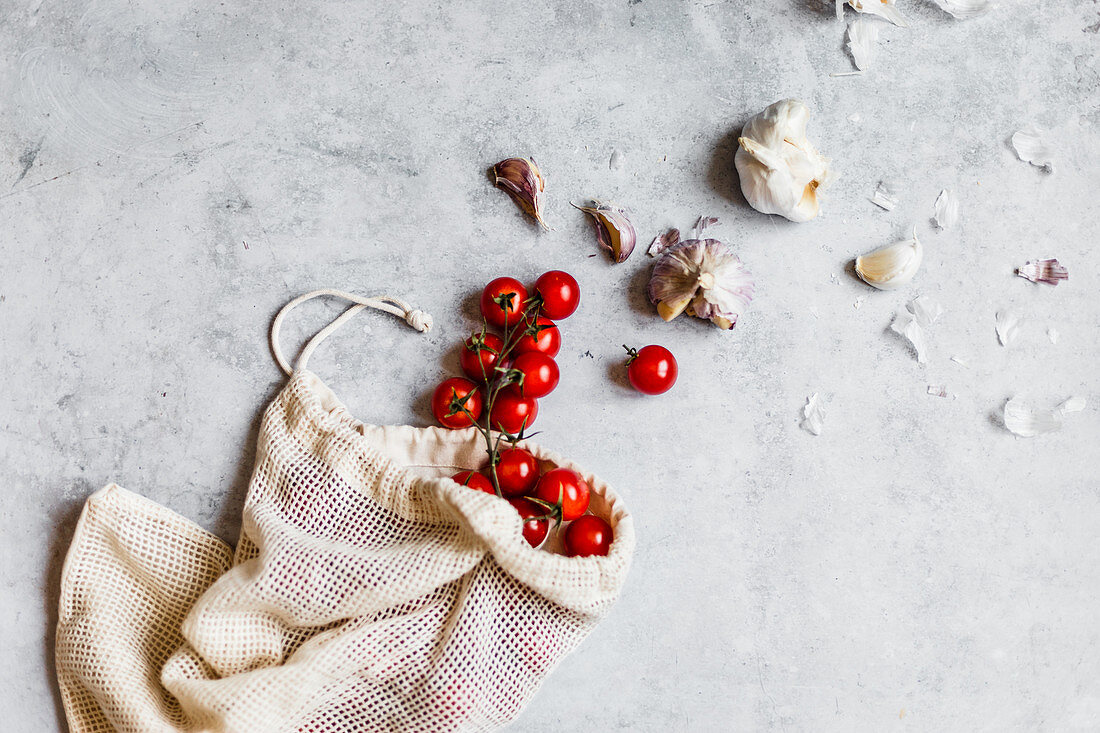 Sustainability - cherry tomatoes and garlic in a cloth bag