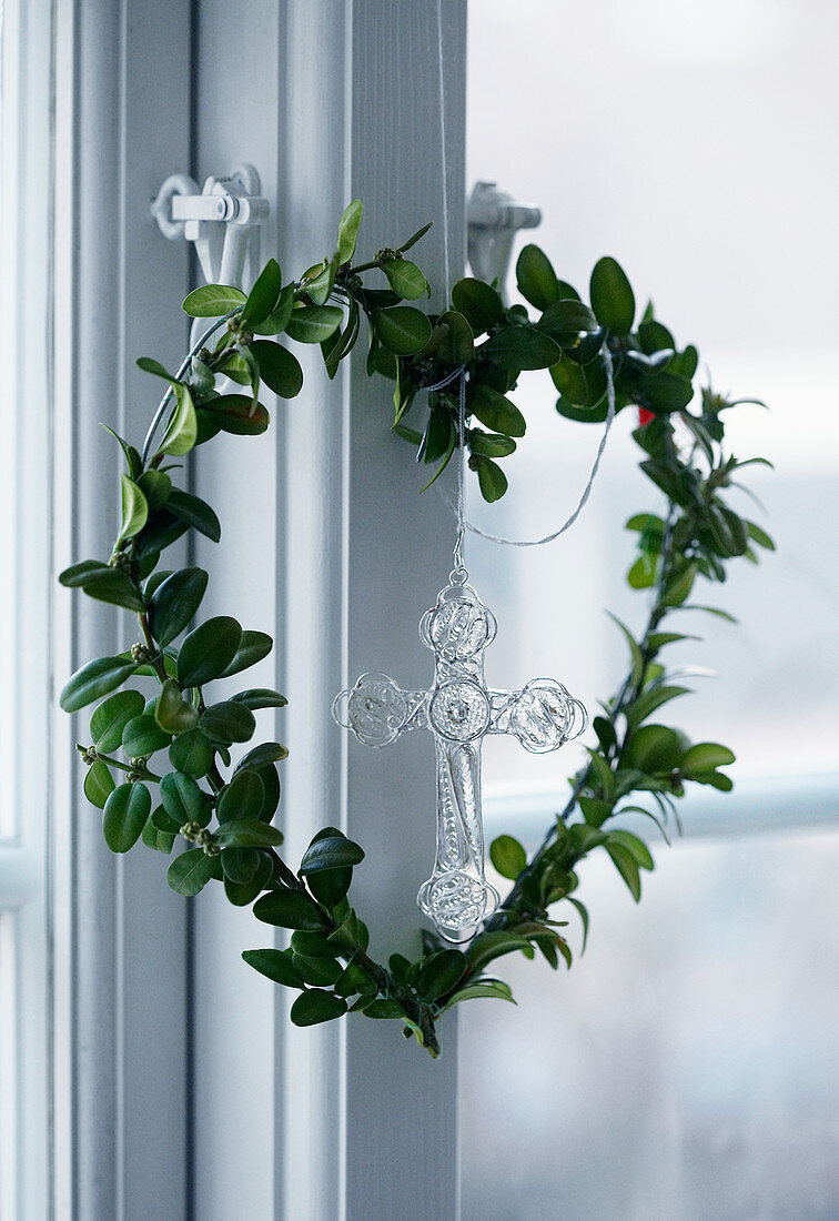 Heart-shaped wreath hanging on window