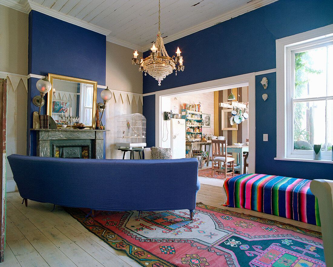 Blue couch in living room with blue accent walls