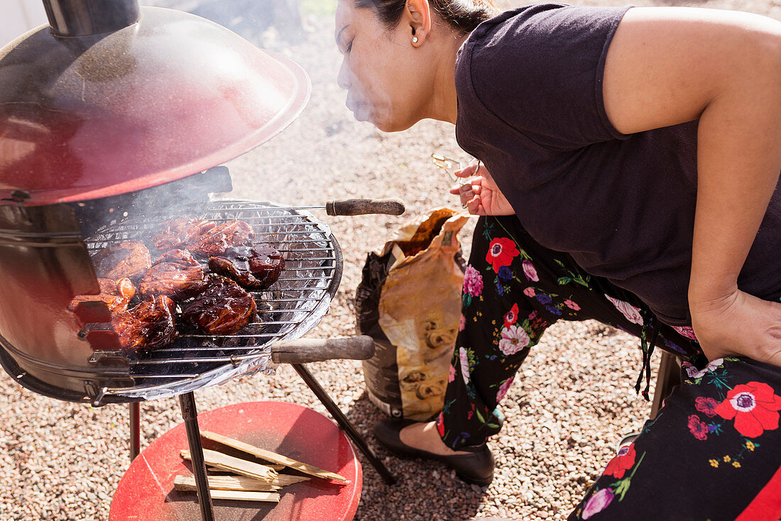 Woman having barbecue