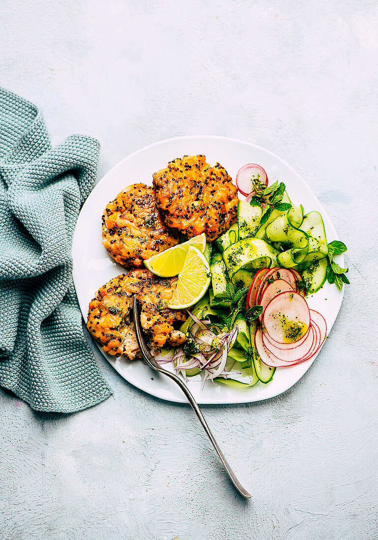 Quinoa and salmon trout patties with cucumber and radish salad