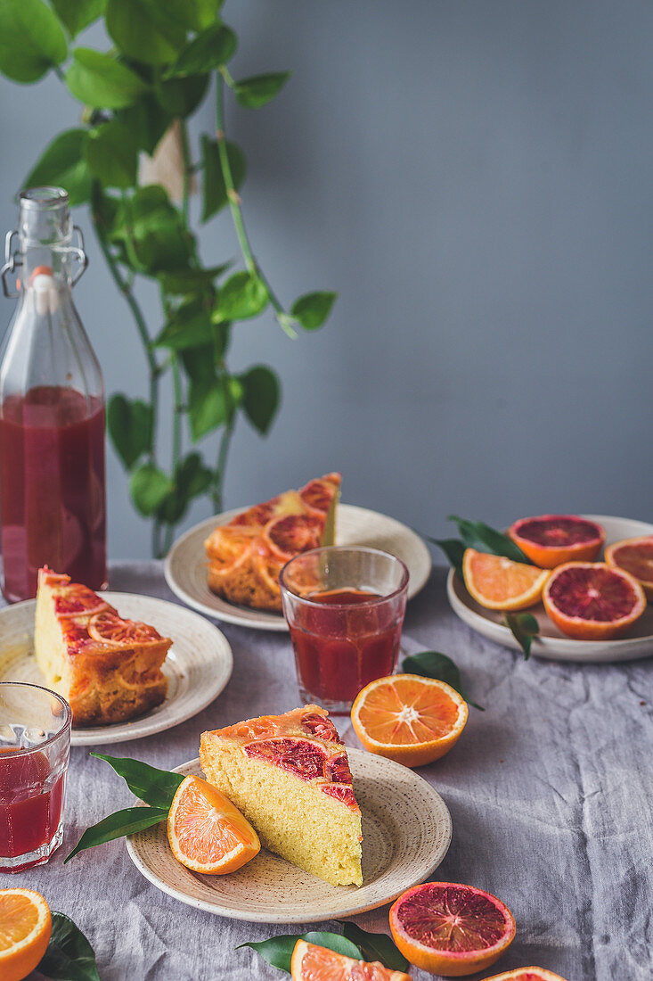 Slices of a blood orange upside down cake and juice