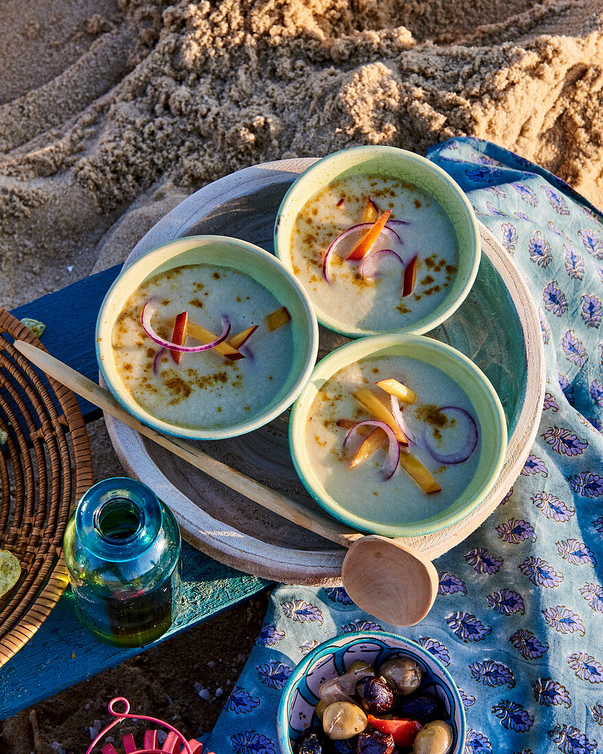Cold fennel cream soup with peach and onion for a beach picnic