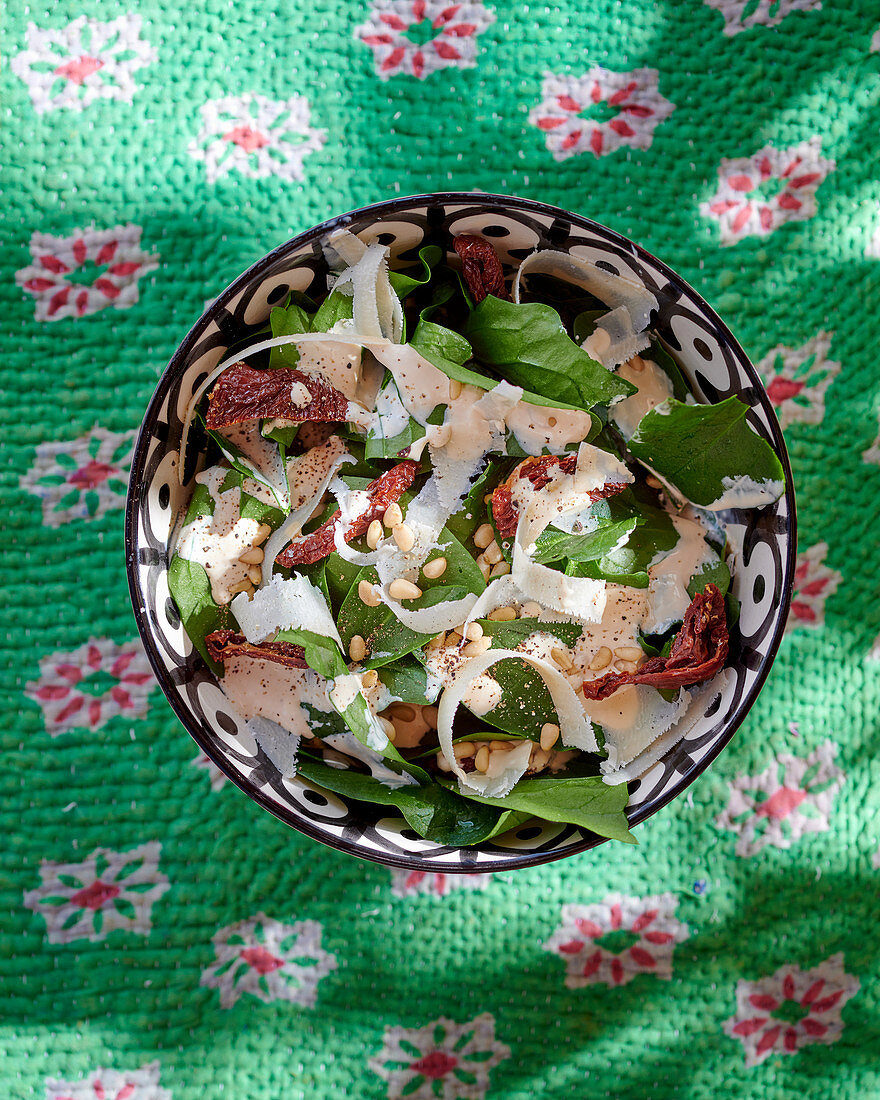 Spinach salad with bacon, pine nuts and parmesan