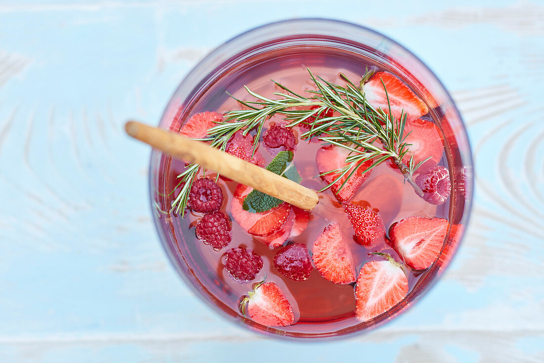 Sangria with strawberries, raspberries, rosemary and mint