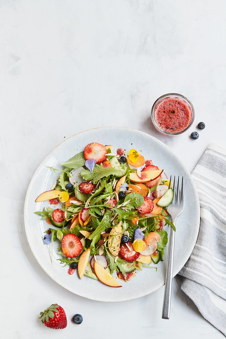 Summer garden salad with berry and horseradish dressing