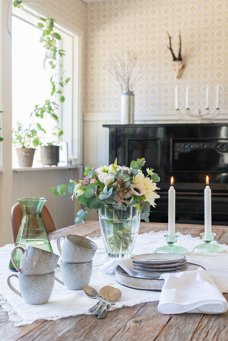 Wooden table set for coffee with a bouquet of flowers