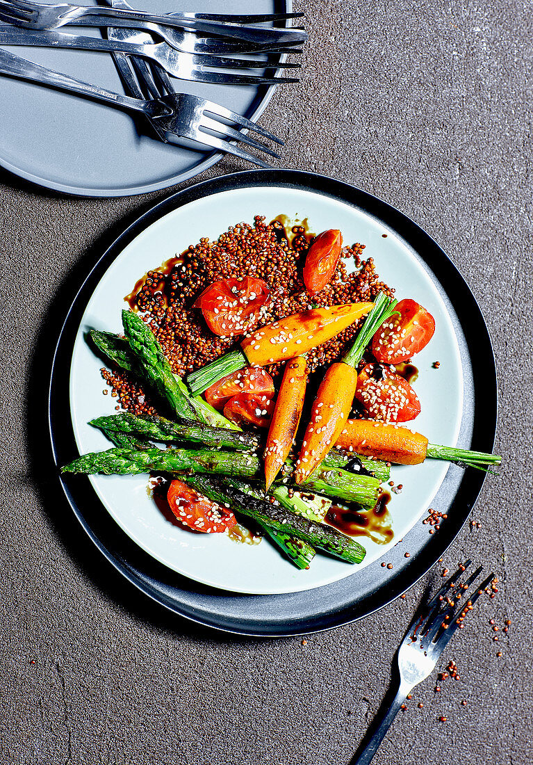 Red quinoa with fried green asparagus, carrots and sesame seeds