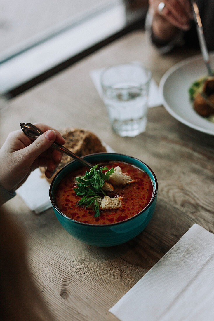 Tomato soup in bowl in restaurant