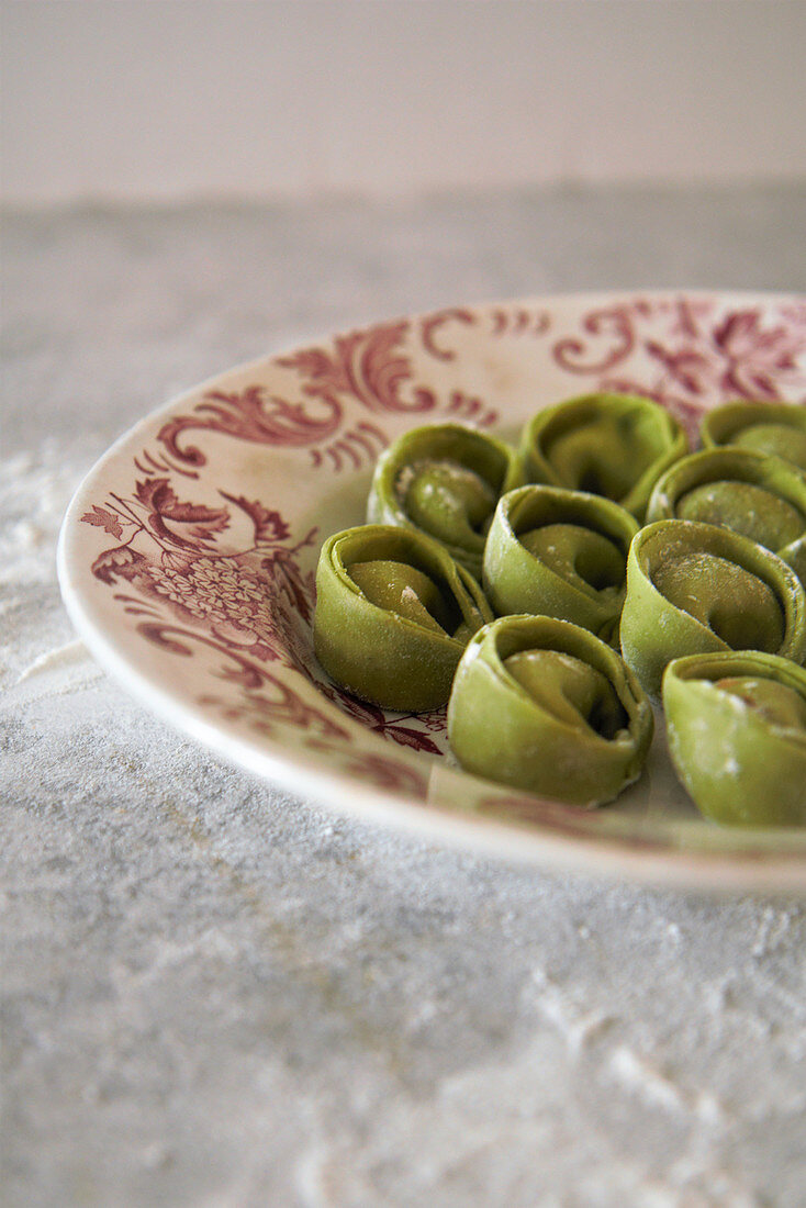 Fresh green cappelletti on a plate