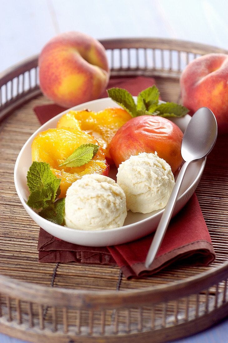 Peach ice cream served with poached peaches
