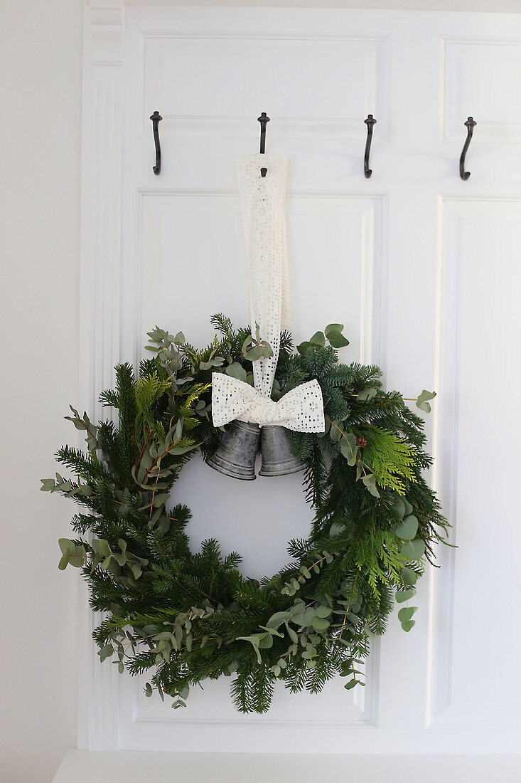 A Christmas wreath with bells on a door