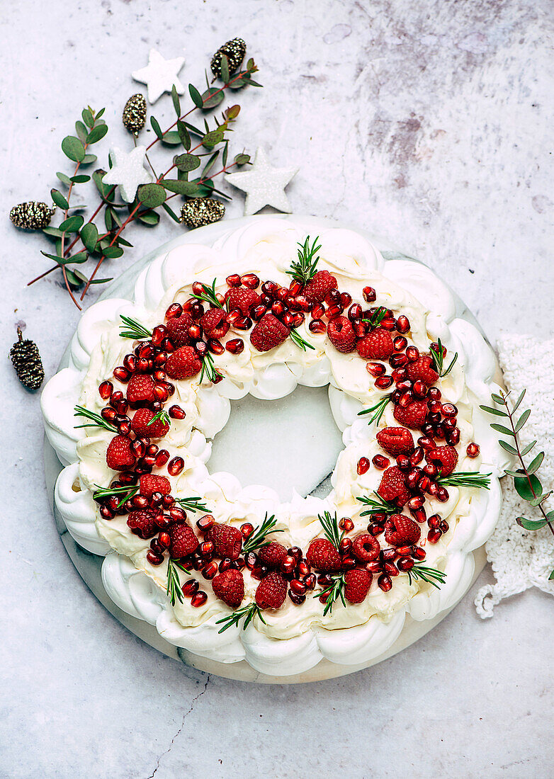 Festive pavlova wreath with raspberries and pomegranate