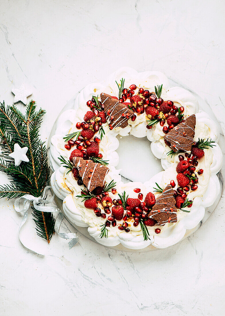 Festive pavlova wreath with local berries and pomegranate