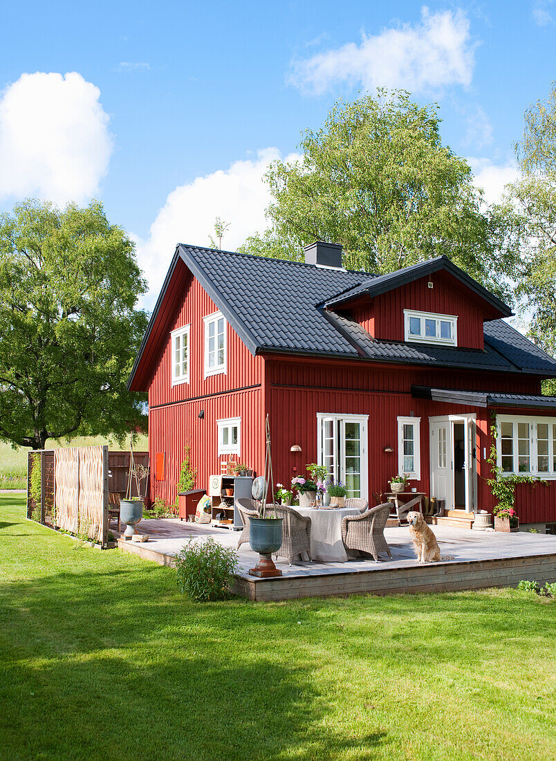 View from garden to Swedish house with terrace