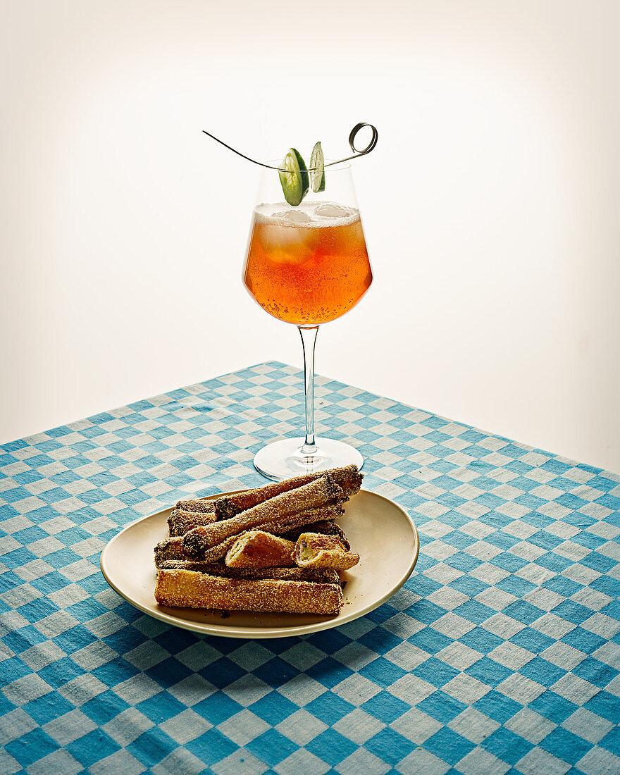 Non-alcoholic herbal liqueur with rose lime and cucumber syrup, with vegan bread sticks